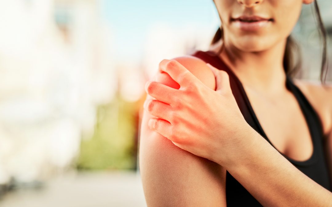 Woman holding shoulder in pain