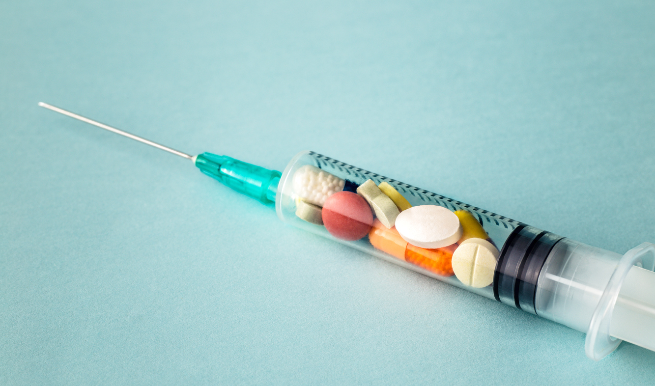 syringe filled with various pills